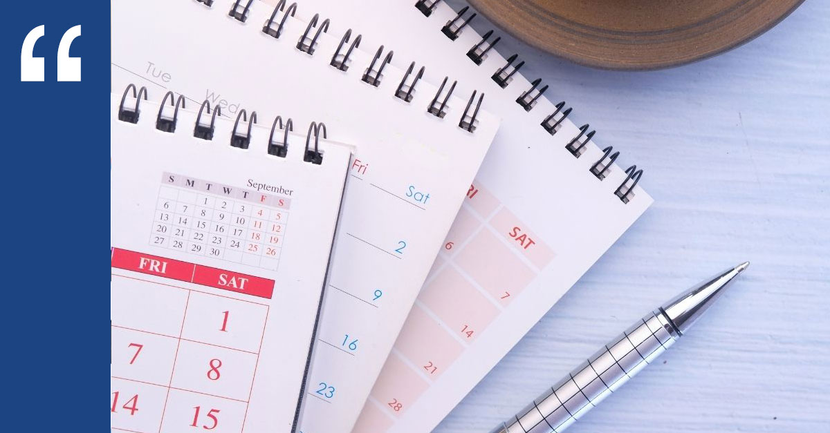 Calendars and a pen on a desk