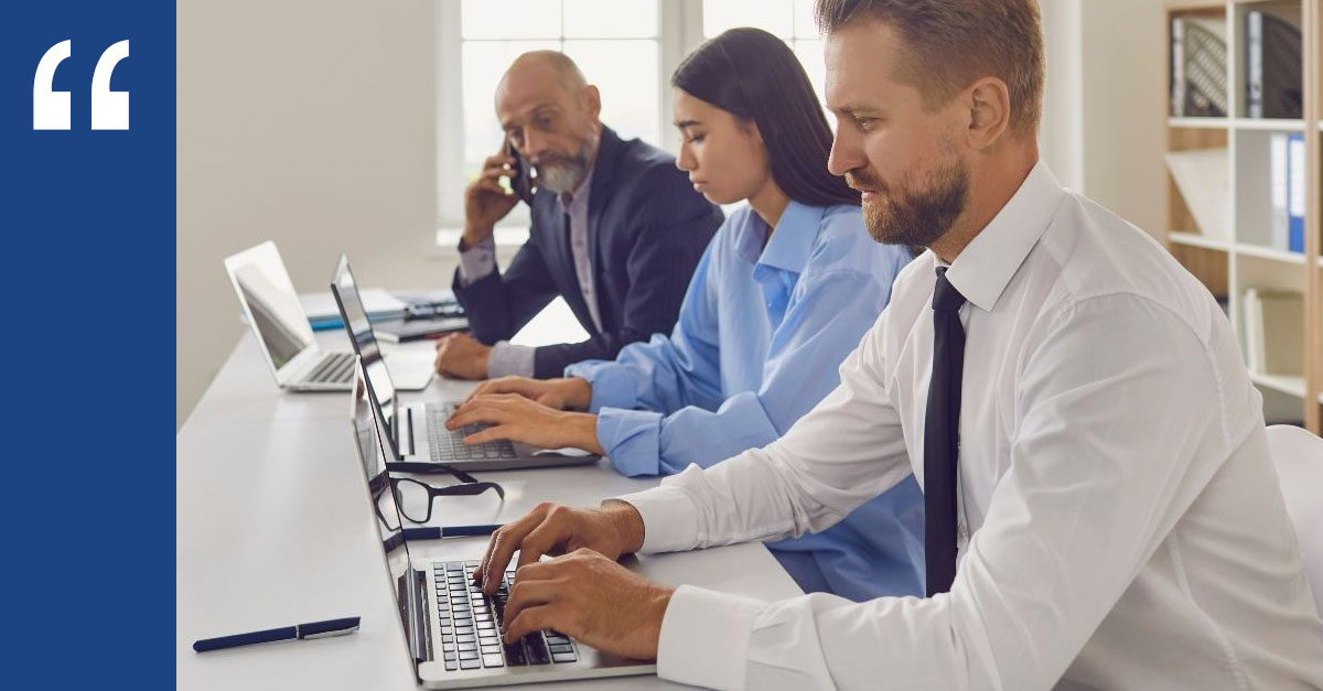 Professionals working on laptops in a meeting room