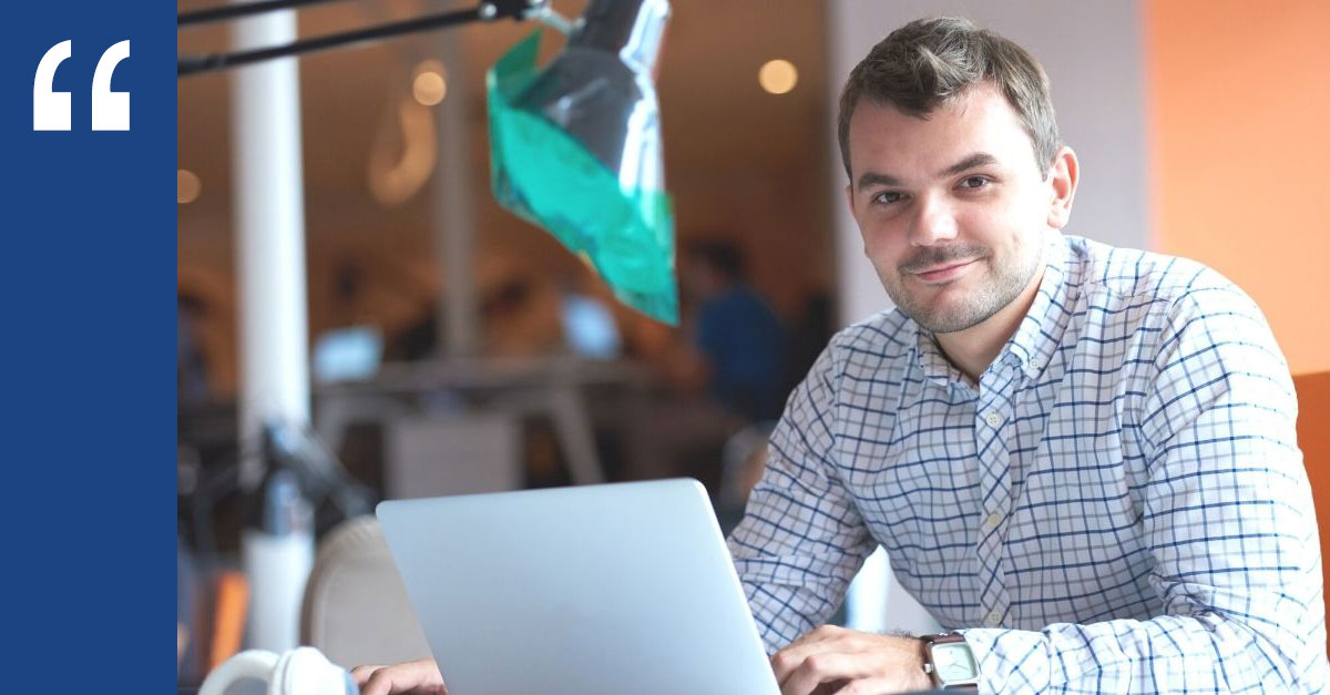 Smiling young professional working on a laptop